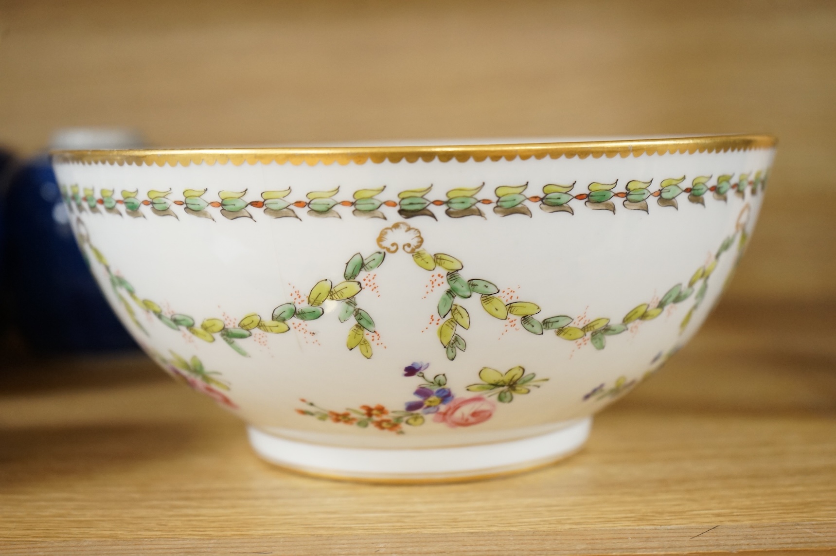 A Continental copy of a Bristol Champions bowl, rose and gilt decorated, 23cm diameter.